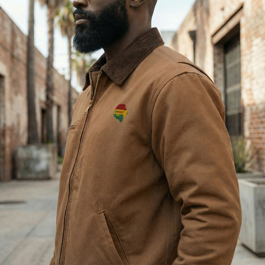 Man wearing a brown jacket with a colorful patch on a street.