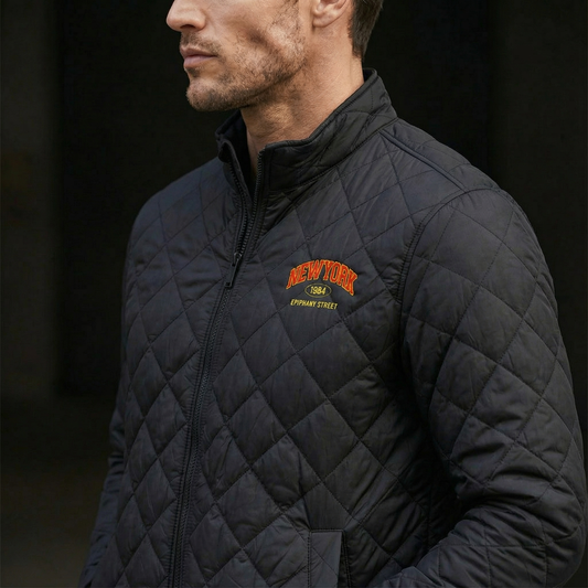 Man wearing a black quilted jacket with 'New York' logo on a dark background
