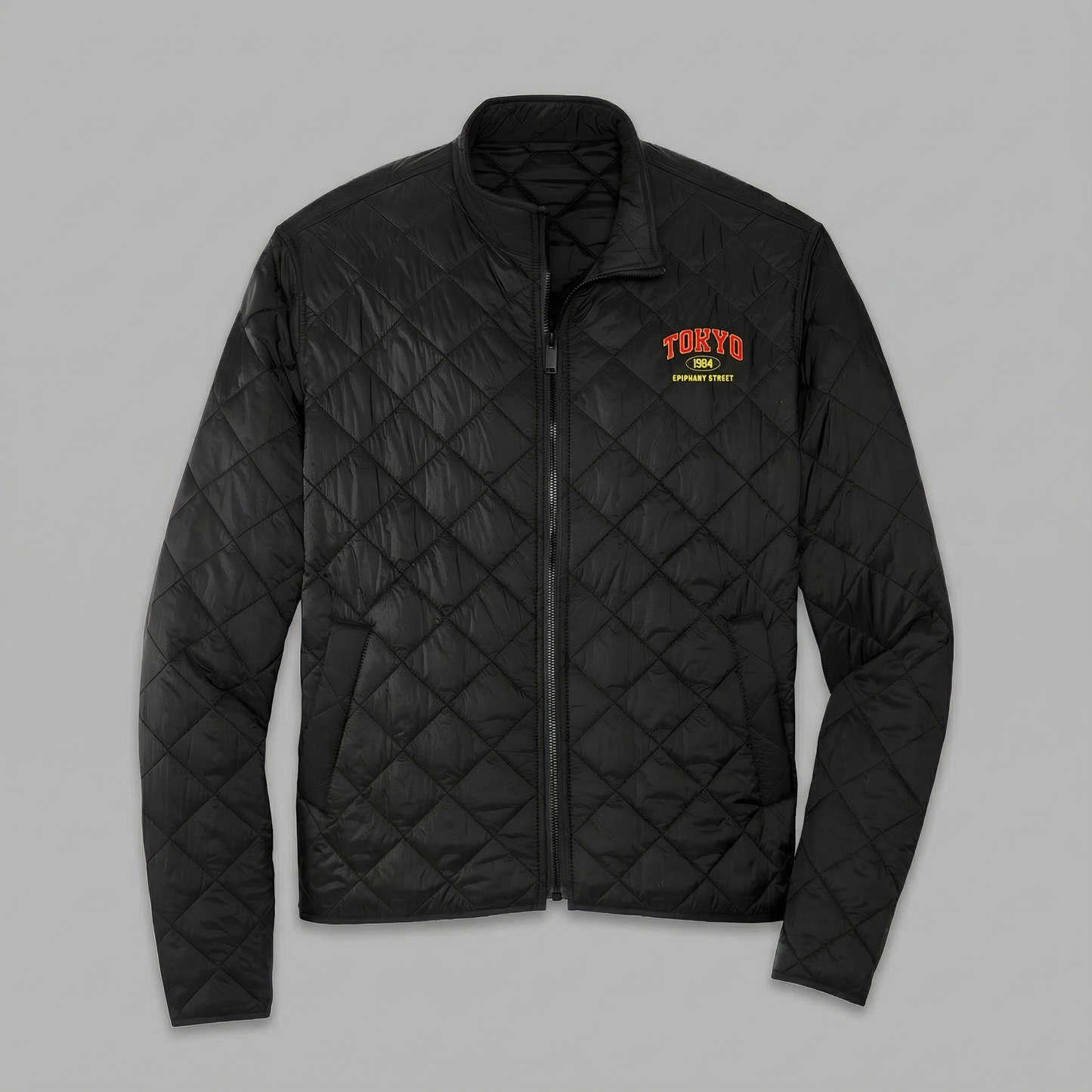 Black quilted jacket with 'Tokyo' logo on a gray background