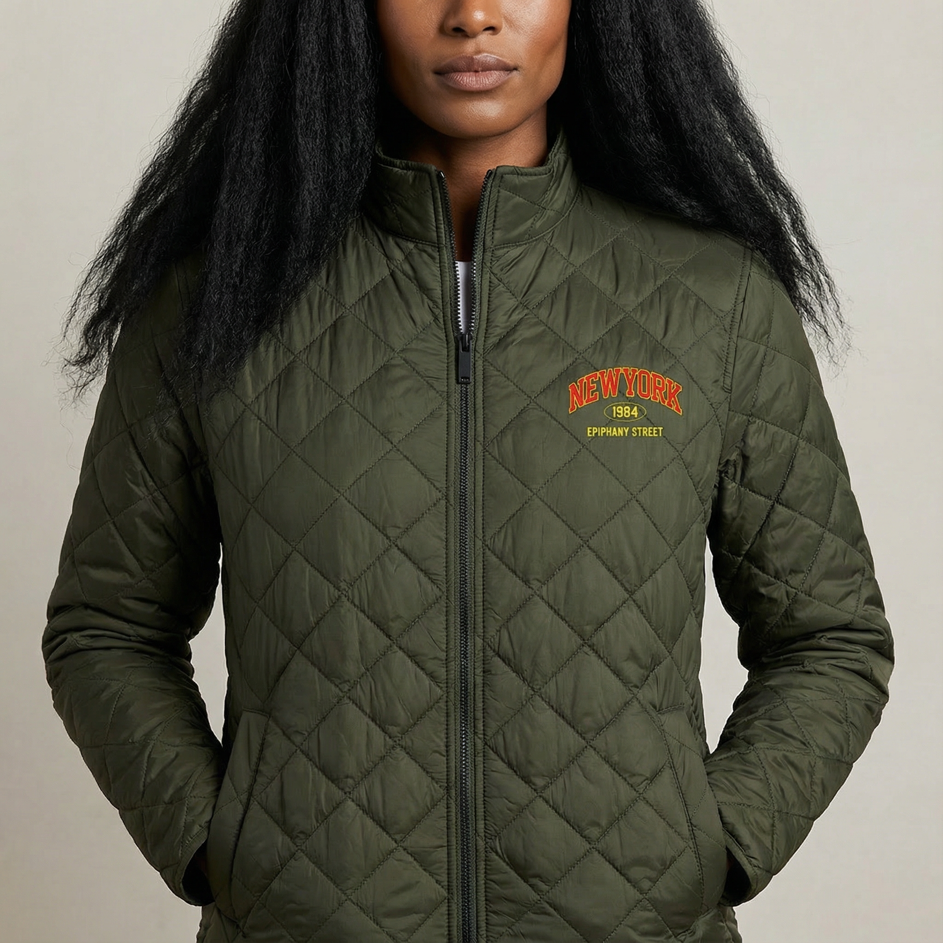 Person wearing a green quilted jacket with text on a neutral background